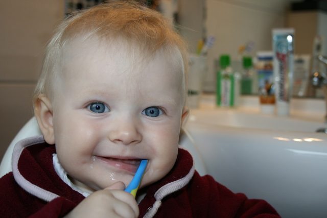 little baby brushing teeth