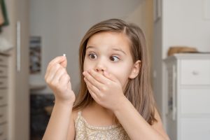 young girl who lost her baby tooth