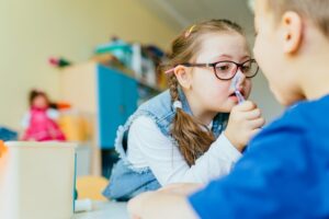 girl with down syndrome with dental tool