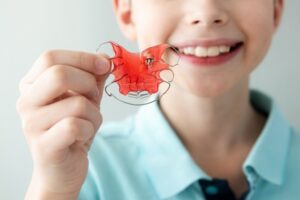 boy holding retainer
