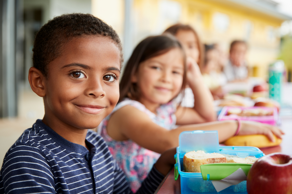 children with lunchboxes at school