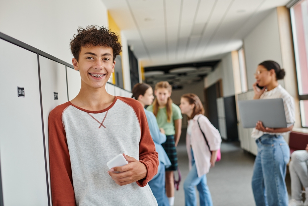 boy in hall at school with braces